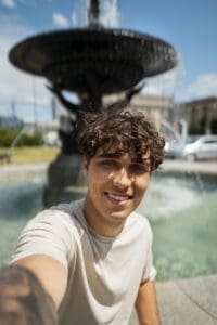 smiley-man-taking-selfie-outdoors-medium-shot